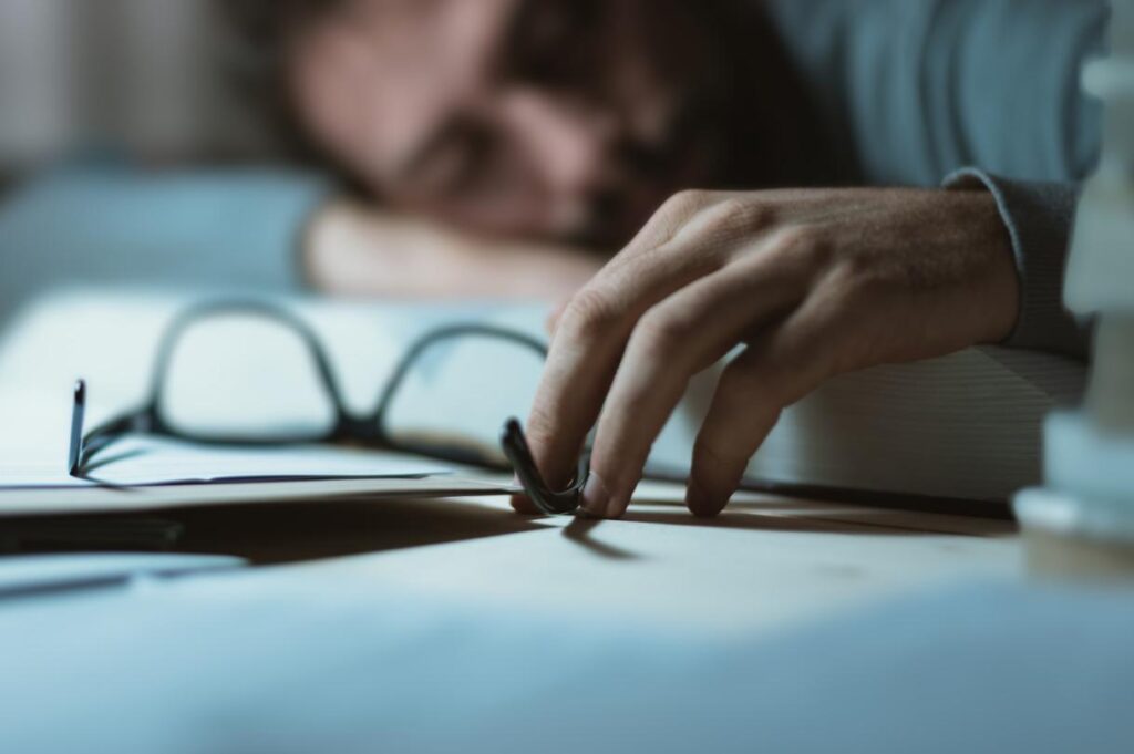 Man lying on table after work, illustrating possible death during a work trip.